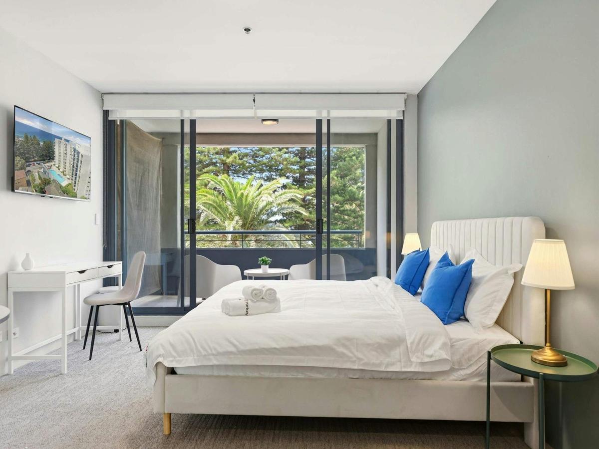 Bright bedroom with large window and balcony access