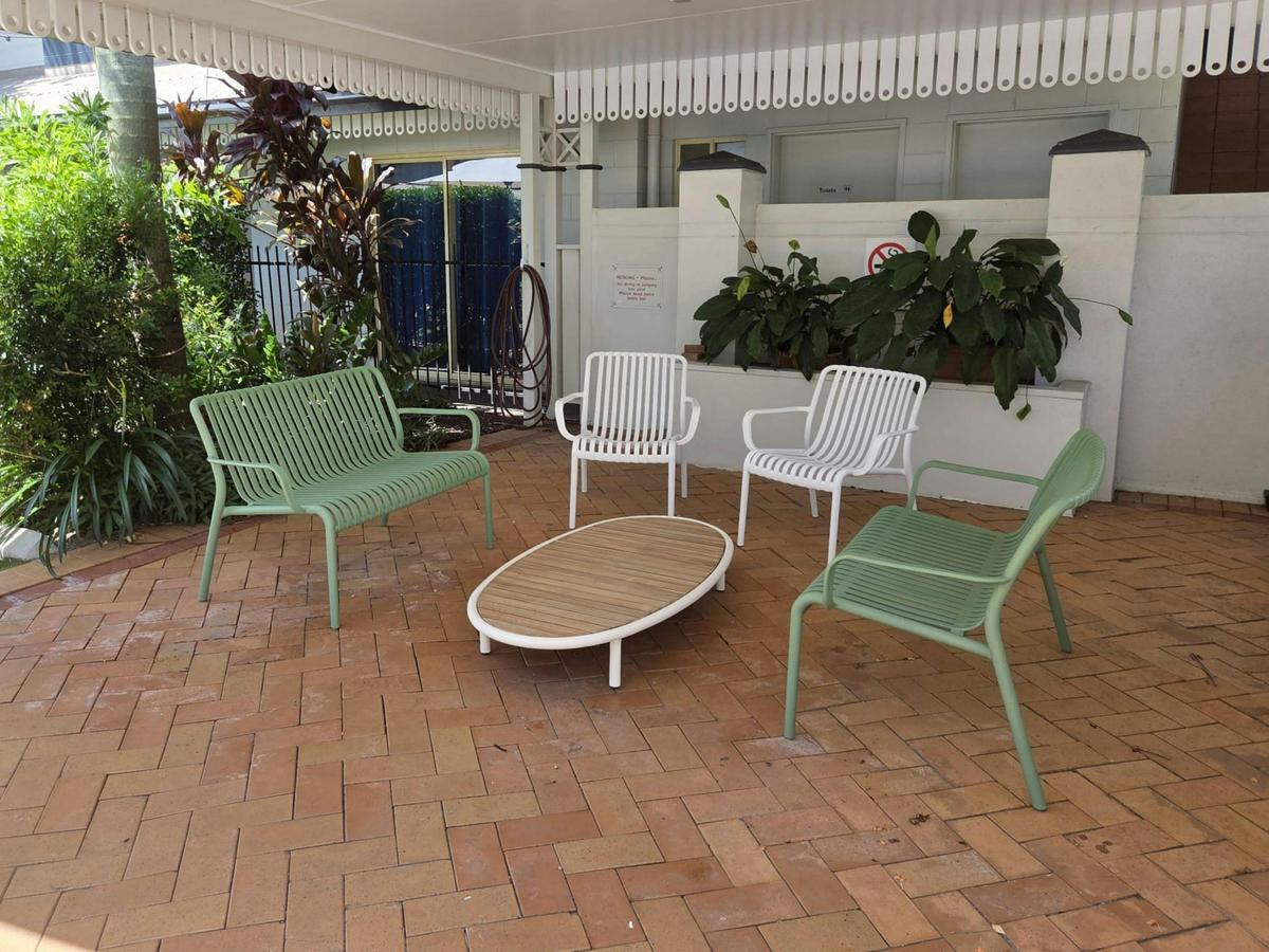 Poolside chairs and table at K2 Queen's Court