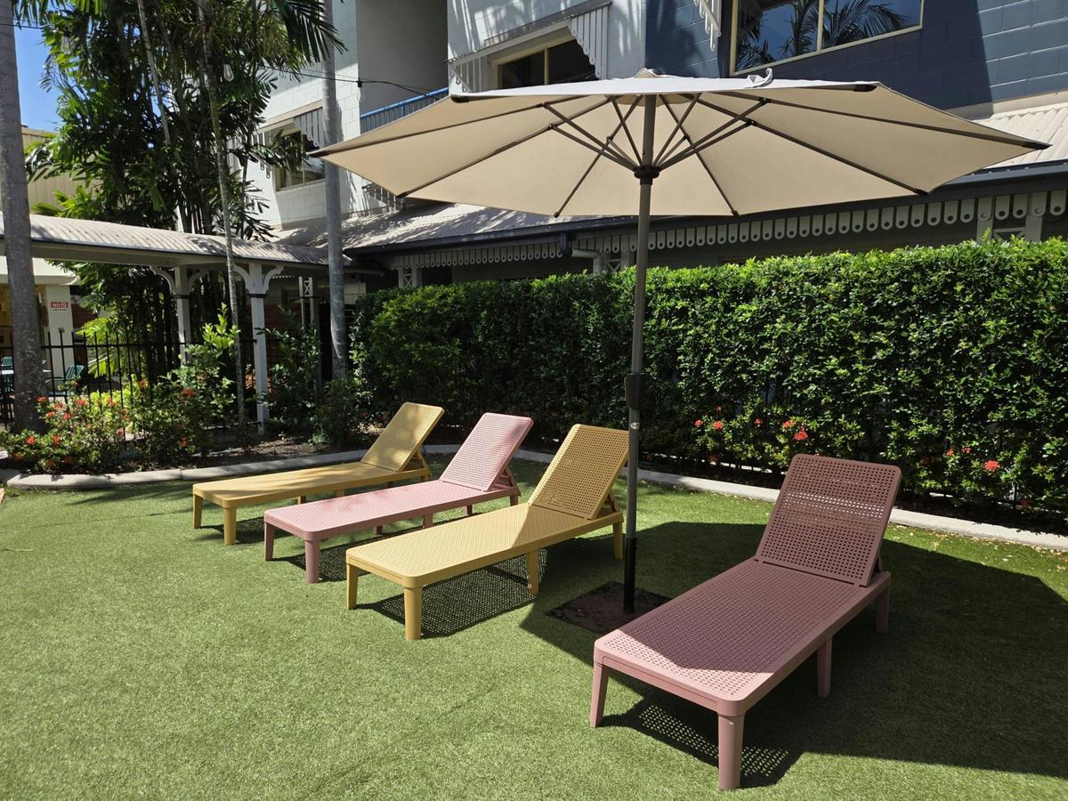 Poolside sun loungers and umbrella at K2 Queen's Court