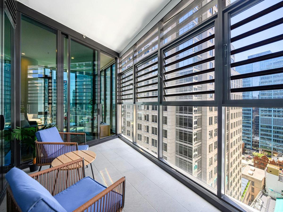Balcony with outdoor seating and city views.