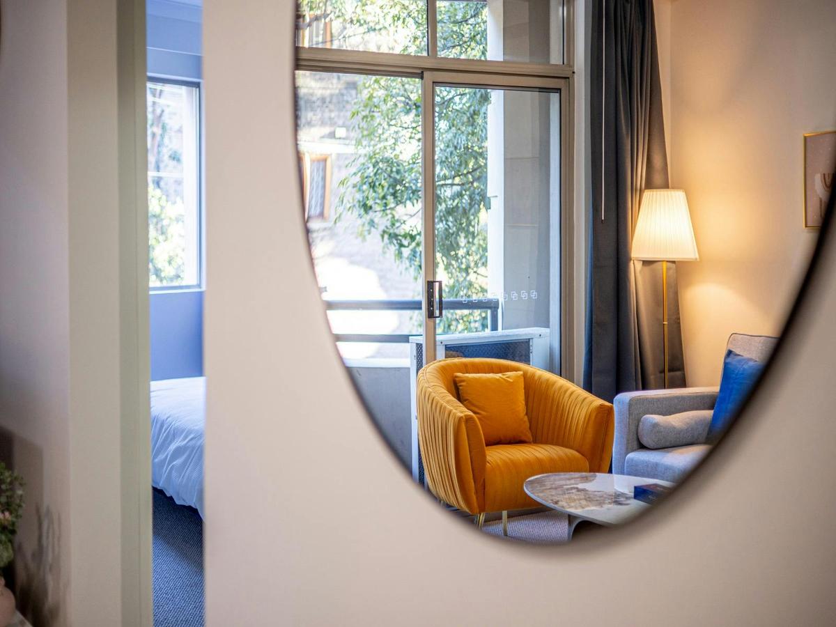 Living room detail showing cozy seating area and reading nook and 1.2m round mirror