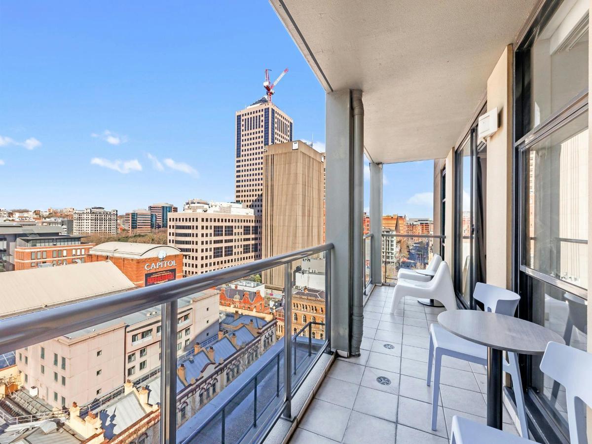 Balcony with outdoor seating and elevated city outlook.