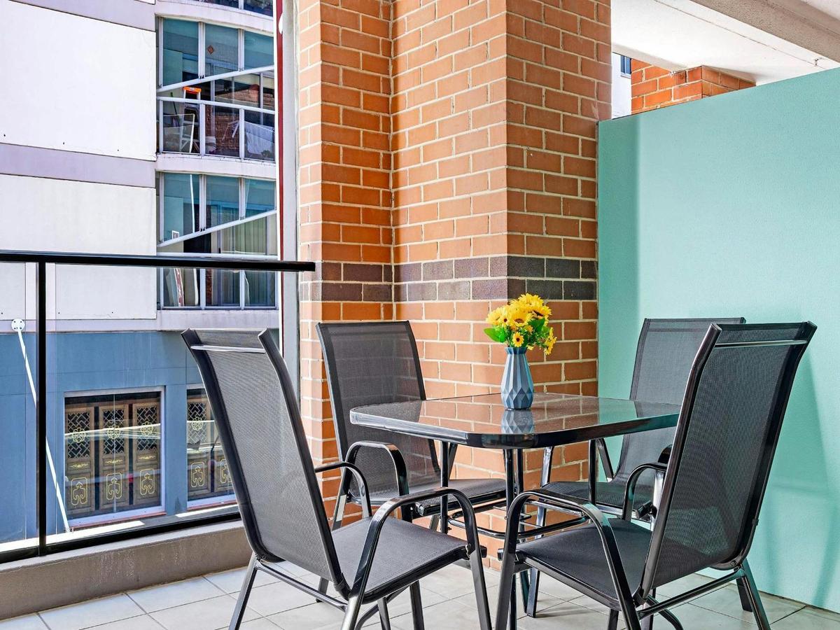 Private balcony with outdoor table and chairs.