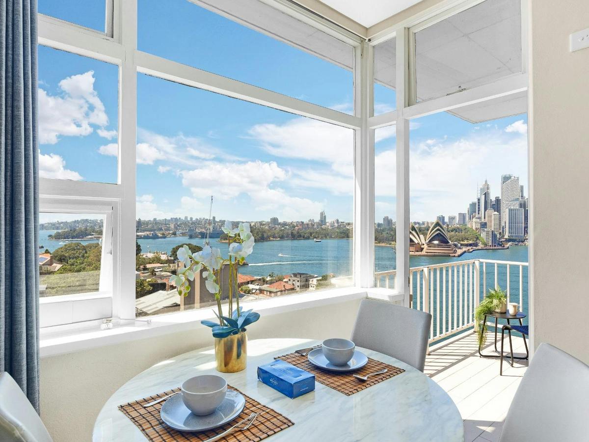 Dining nook positioned by large windows overlooking the harbour.