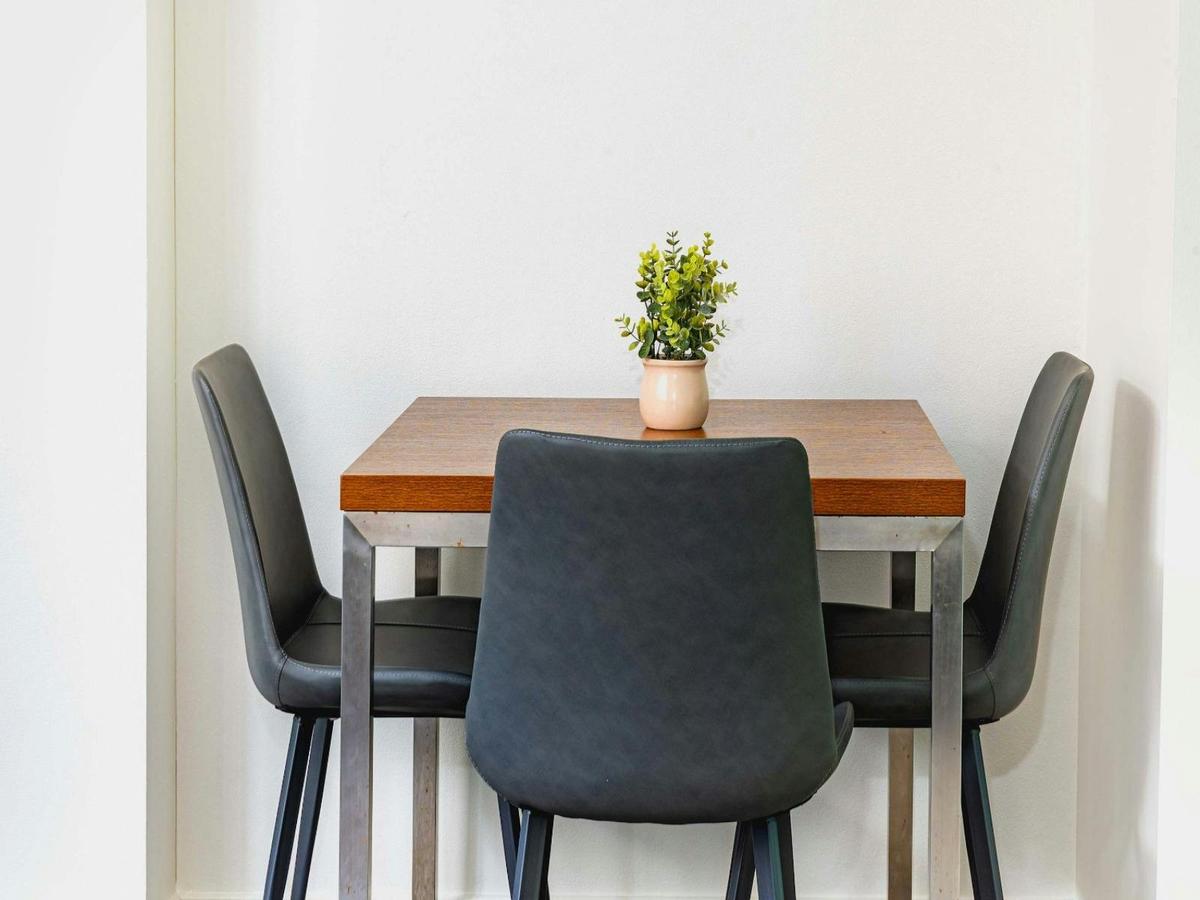 Small dining setting with table and chairs.