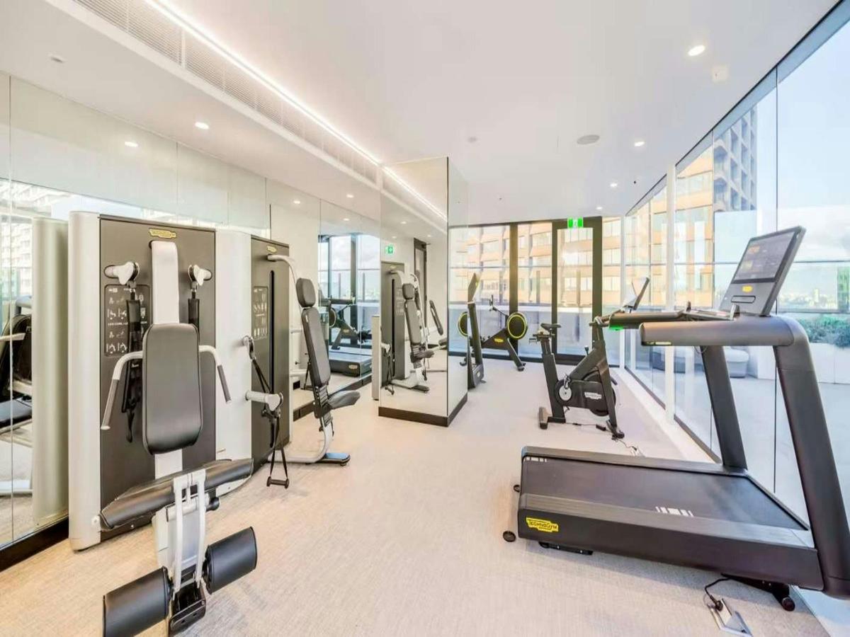 Shared fitness centre with cardio equipment and floor-to-ceiling windows