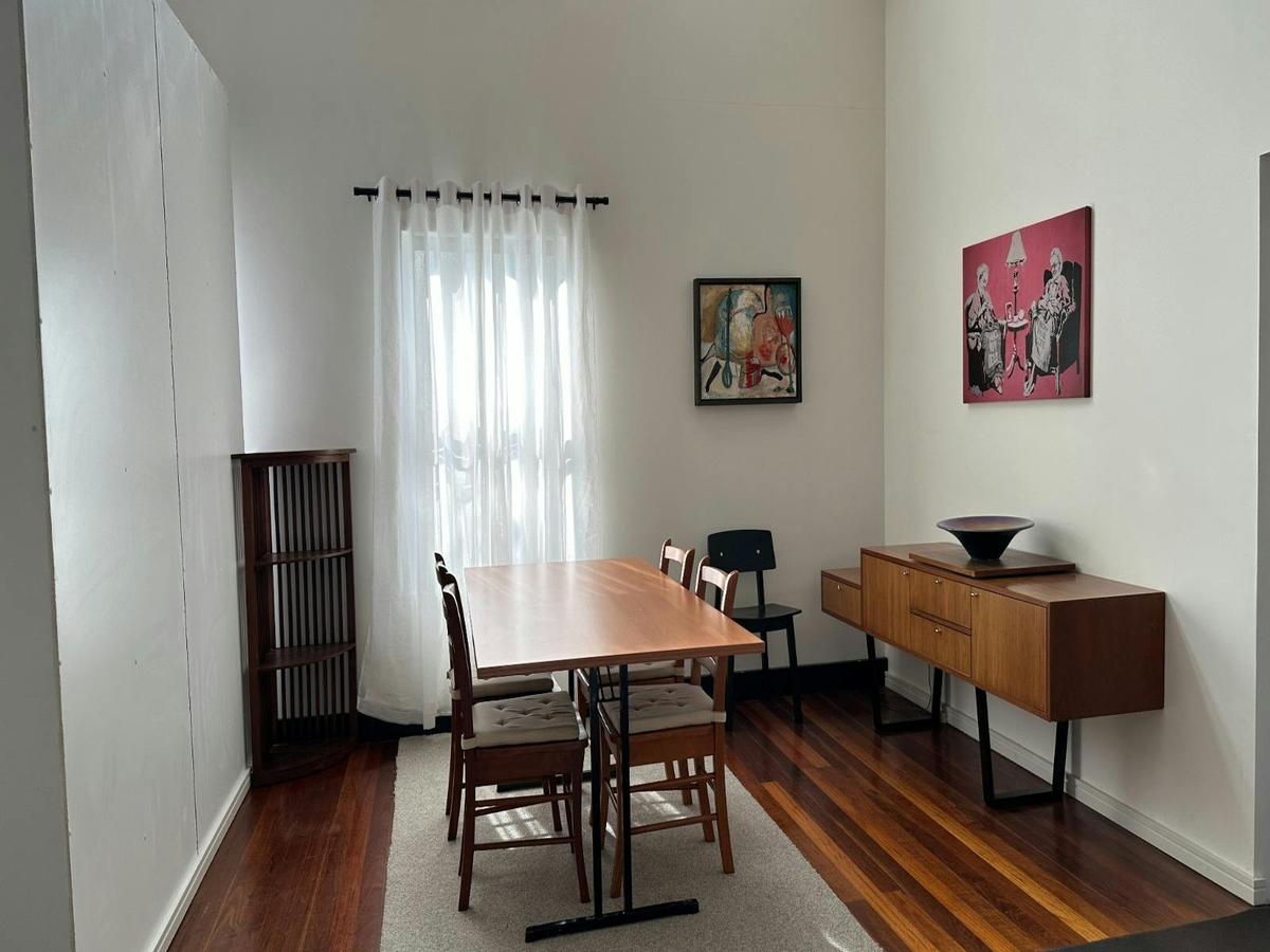 Dining area with table setting and natural light from window.