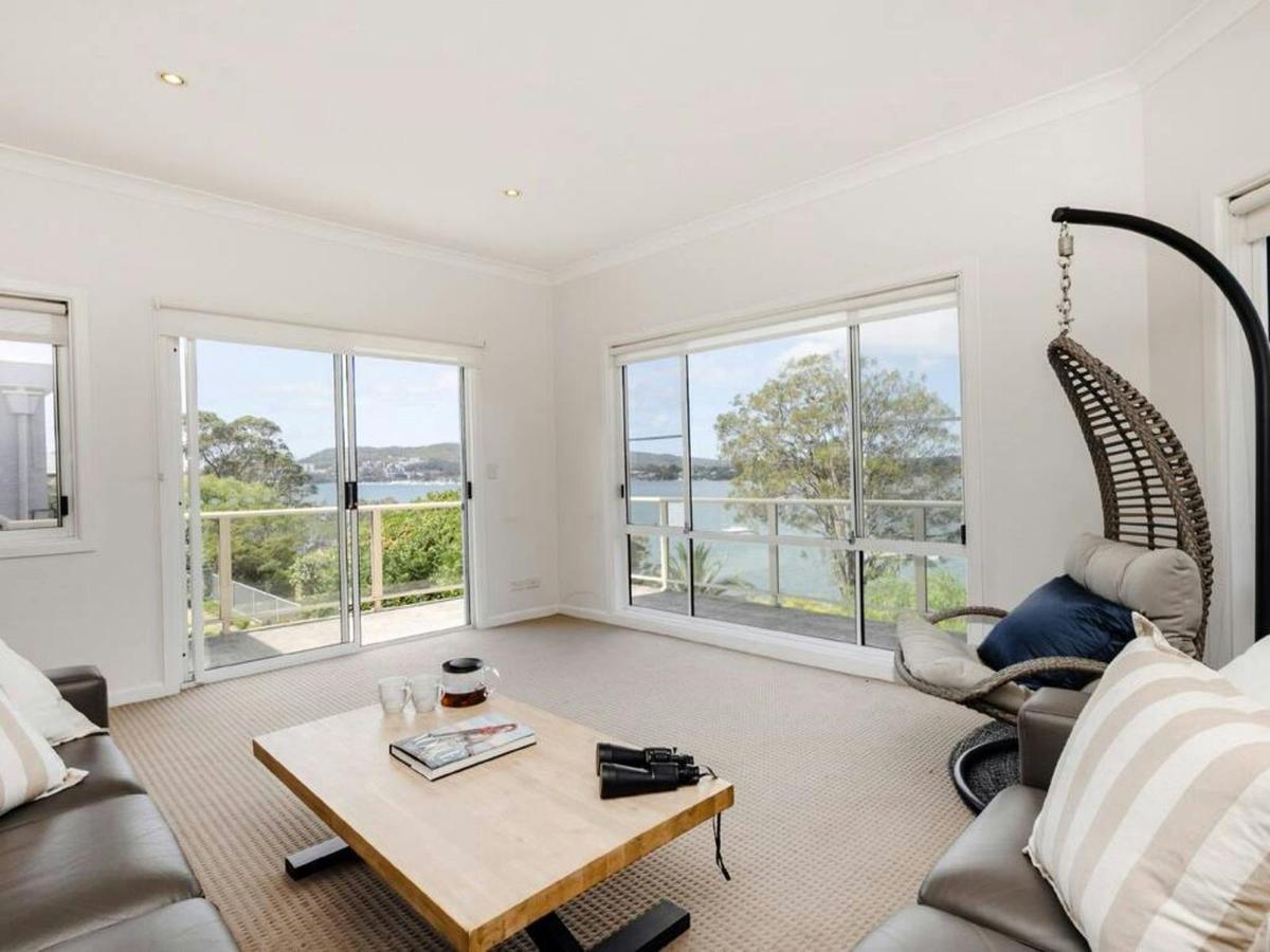 Light-filled lounge area with comfortable sofa, coffee table and picturesque water views.