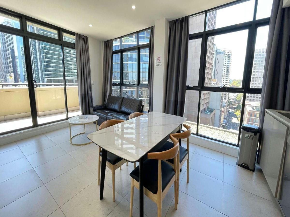 Open-plan dining area with large windows, city views, and natural light throughout.