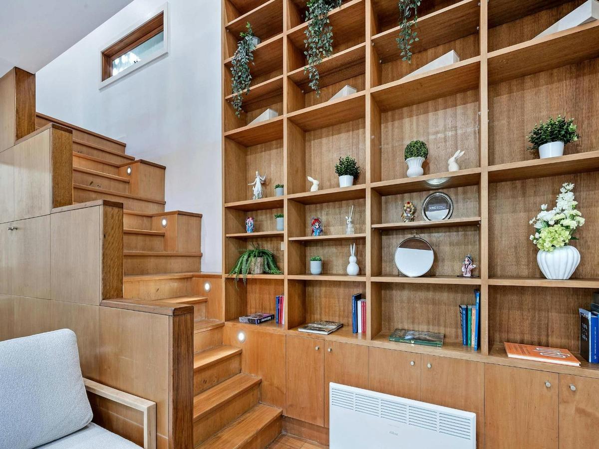 Staircase and custom timber shelving detail with decorative styling.