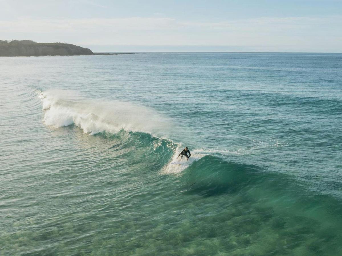 Surfing at Rennies Beach