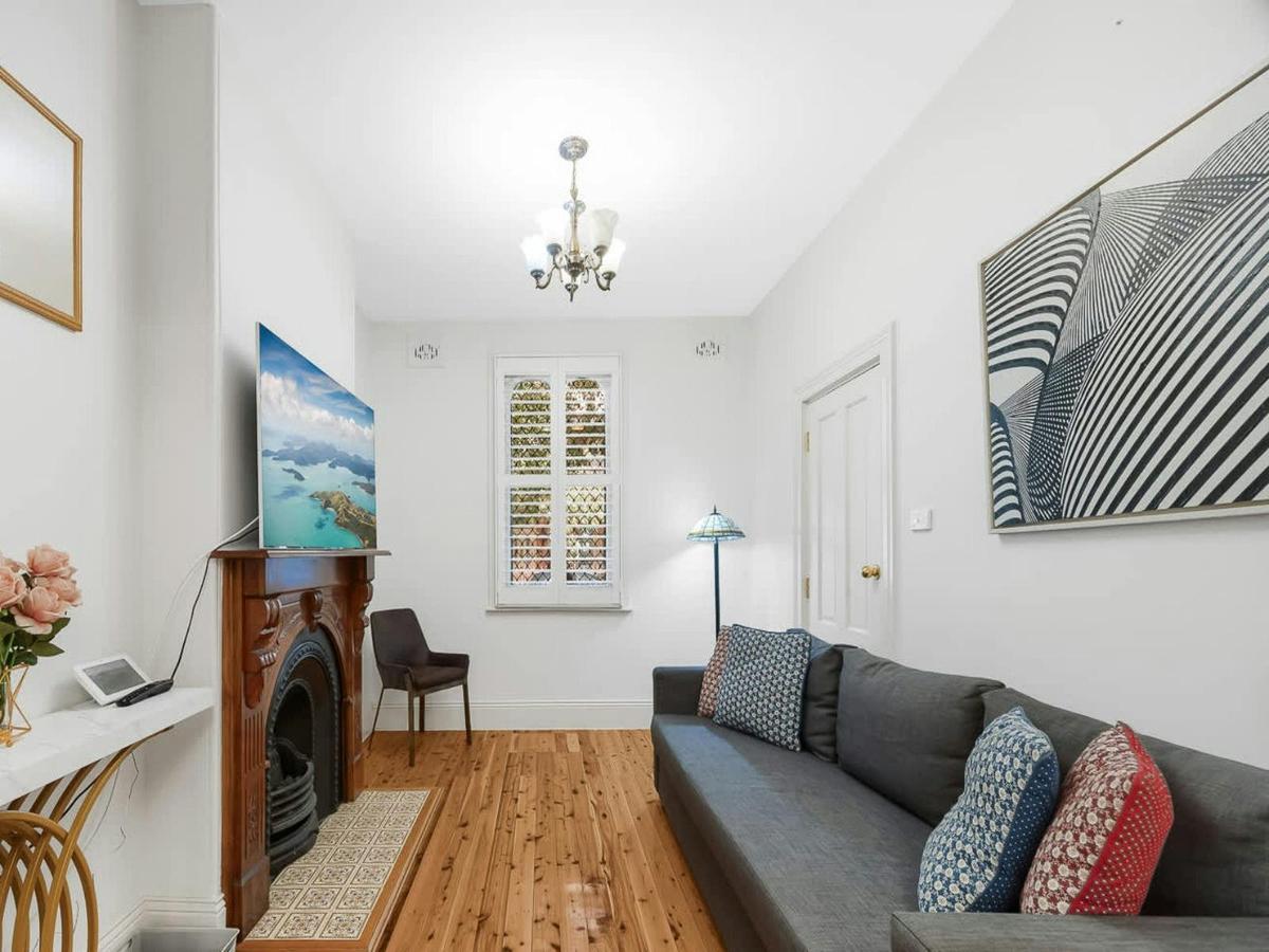 Comfortable living room with sofa, fireplace, and heritage features