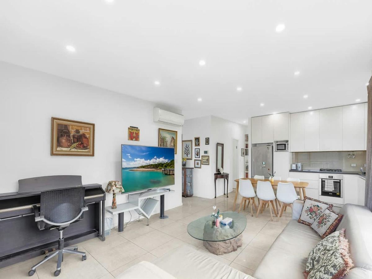 Light-filled living room with comfortable seating, TV, and stylish décor.
