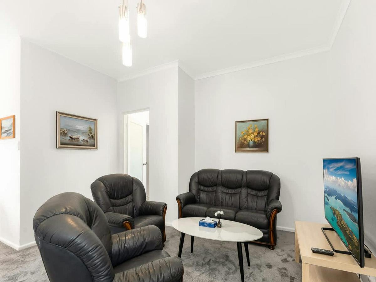 Comfortable lounge with leather sofas, coffee table, and bright open living space.