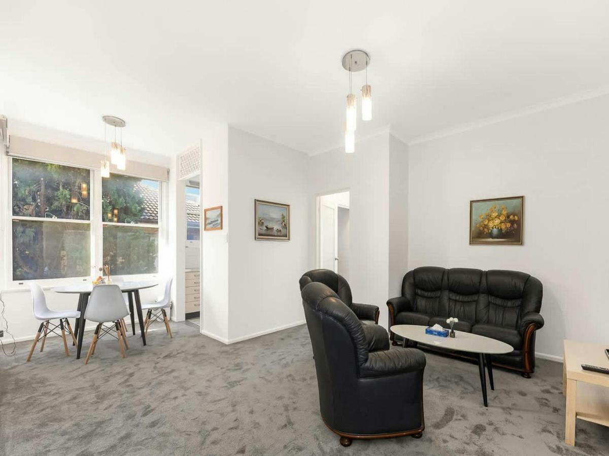 Open-plan living and dining area with comfortable seating and large windows.