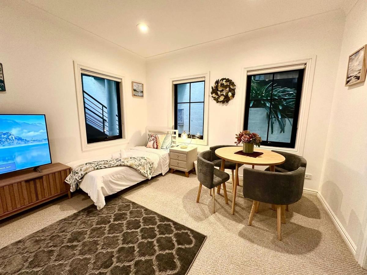 Downstairs Lounge / Kids Room featuring 2 single beds, comfortable layout, and TV area.