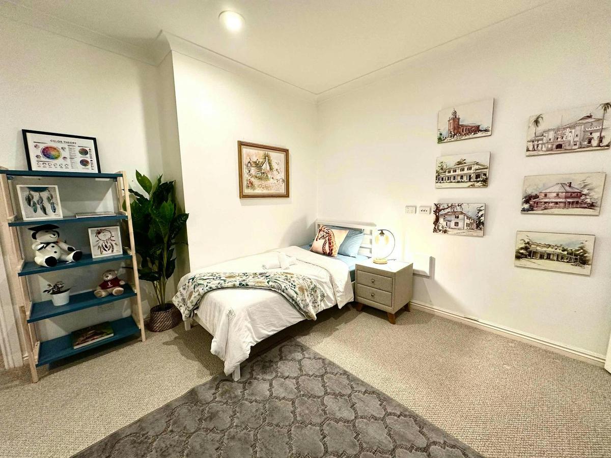 Downstairs Room 3 featuring a double bed, shelving, and cosy styling.