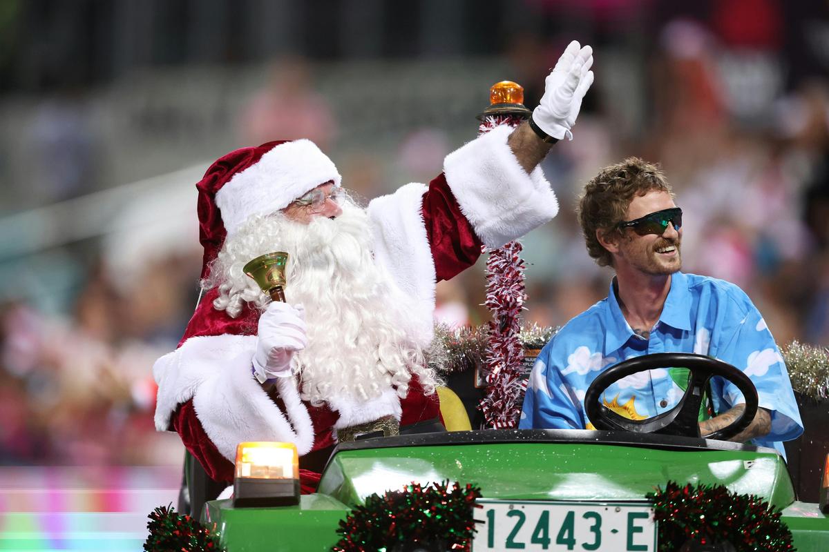 Santa rides on the groundskeeper buggy to greet all the attendees at the Christmas at the Sixers.