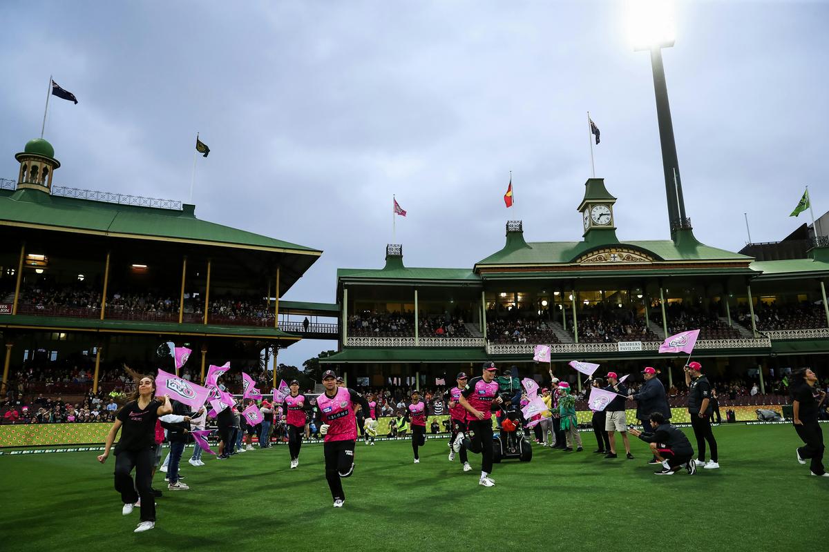 Sixers players run out at the SCG.