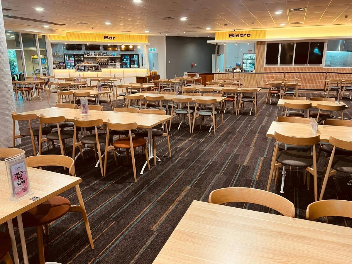 Standing view photo of the Bistro dining room with table & chair layout.