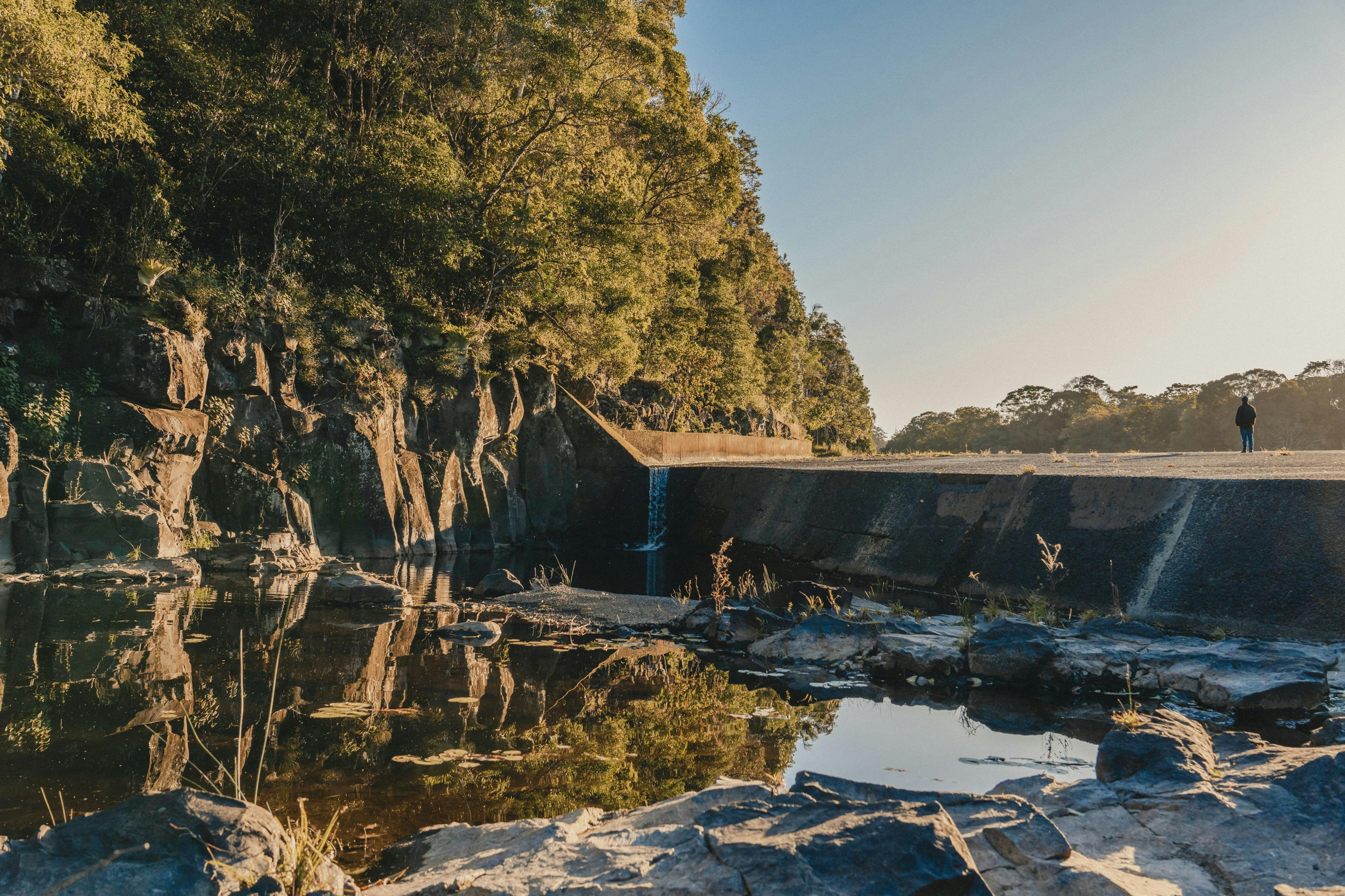 Person walking along the dam wall
