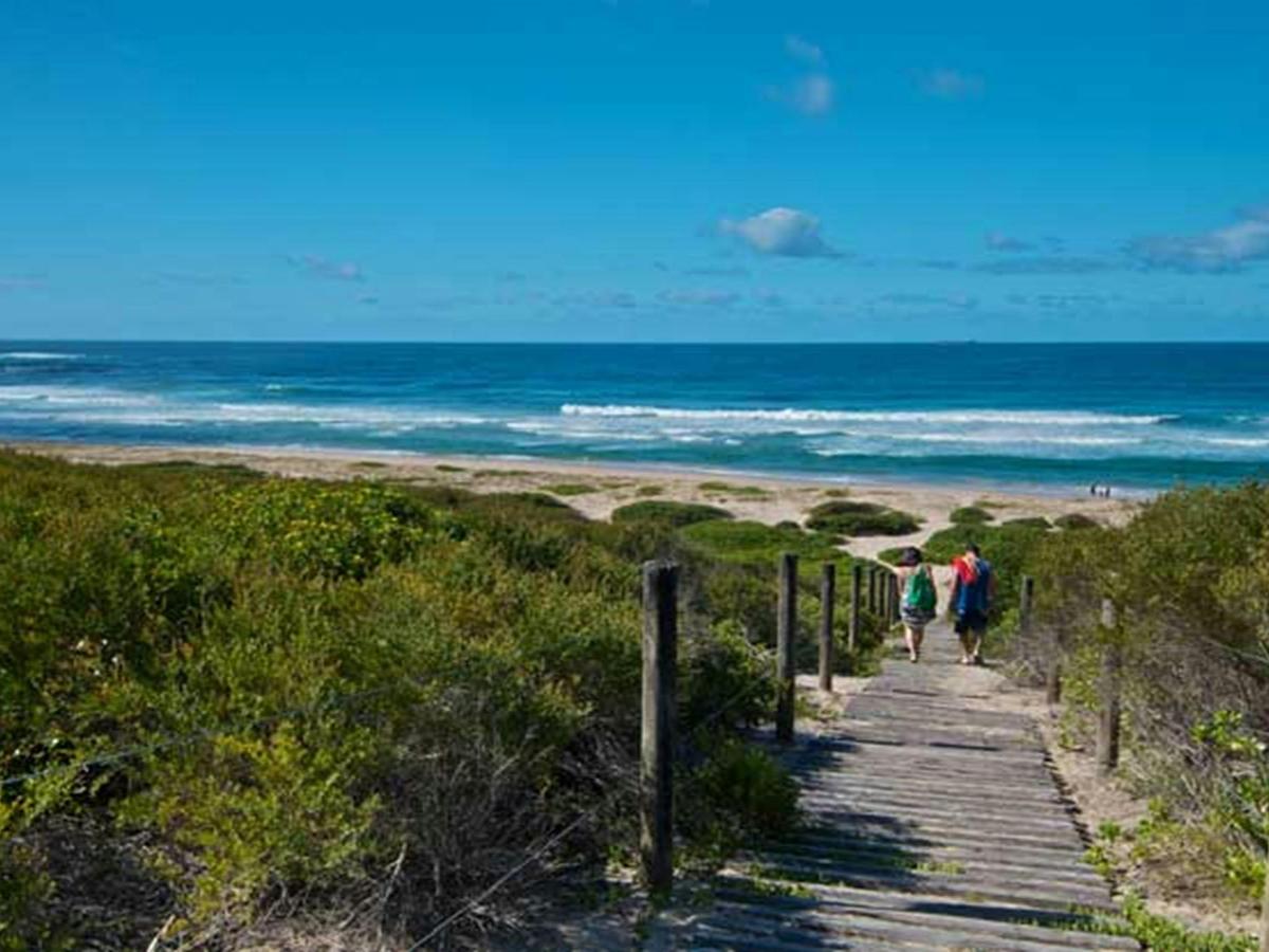 Two people on the track to Pelican Beach. Photo: John Spencer