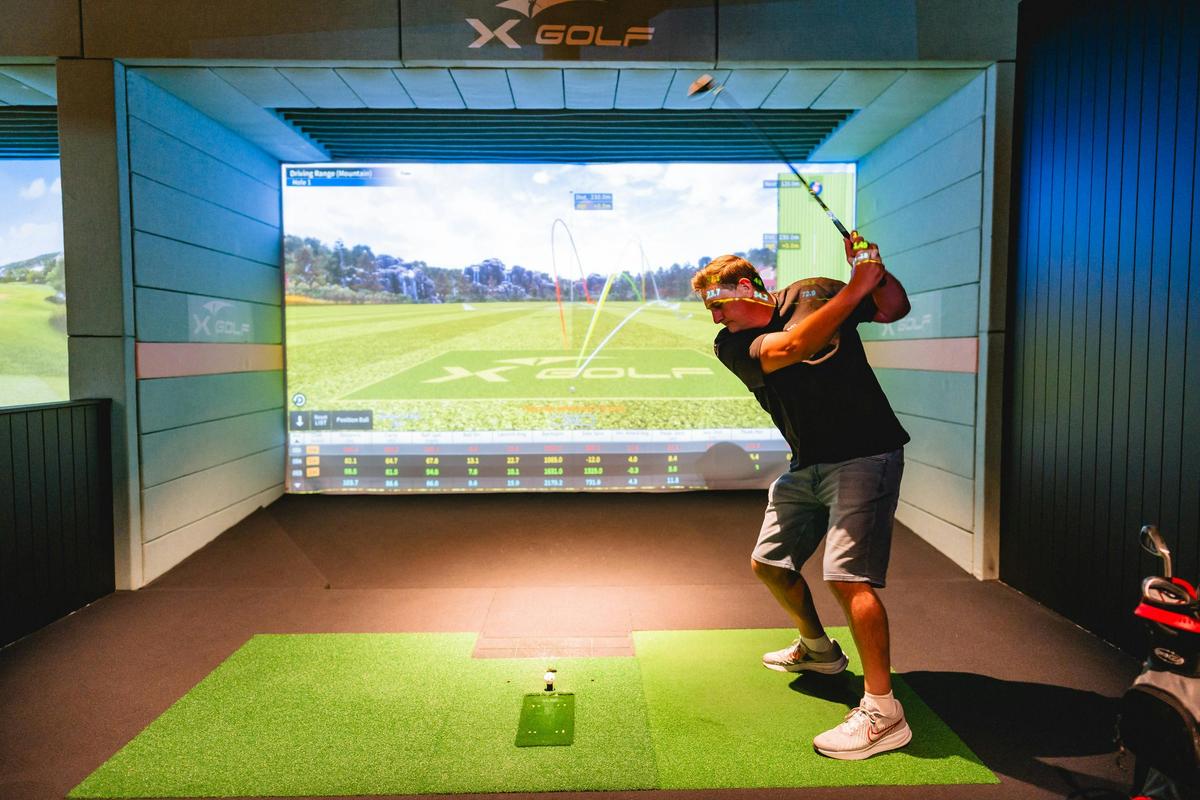 Golfer at X-Golf Venue