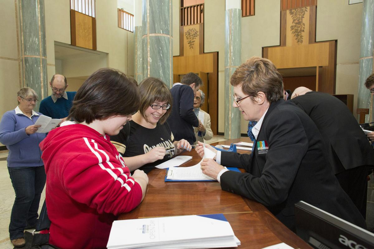 A Visitor Services Officer greets guest to Parliament House