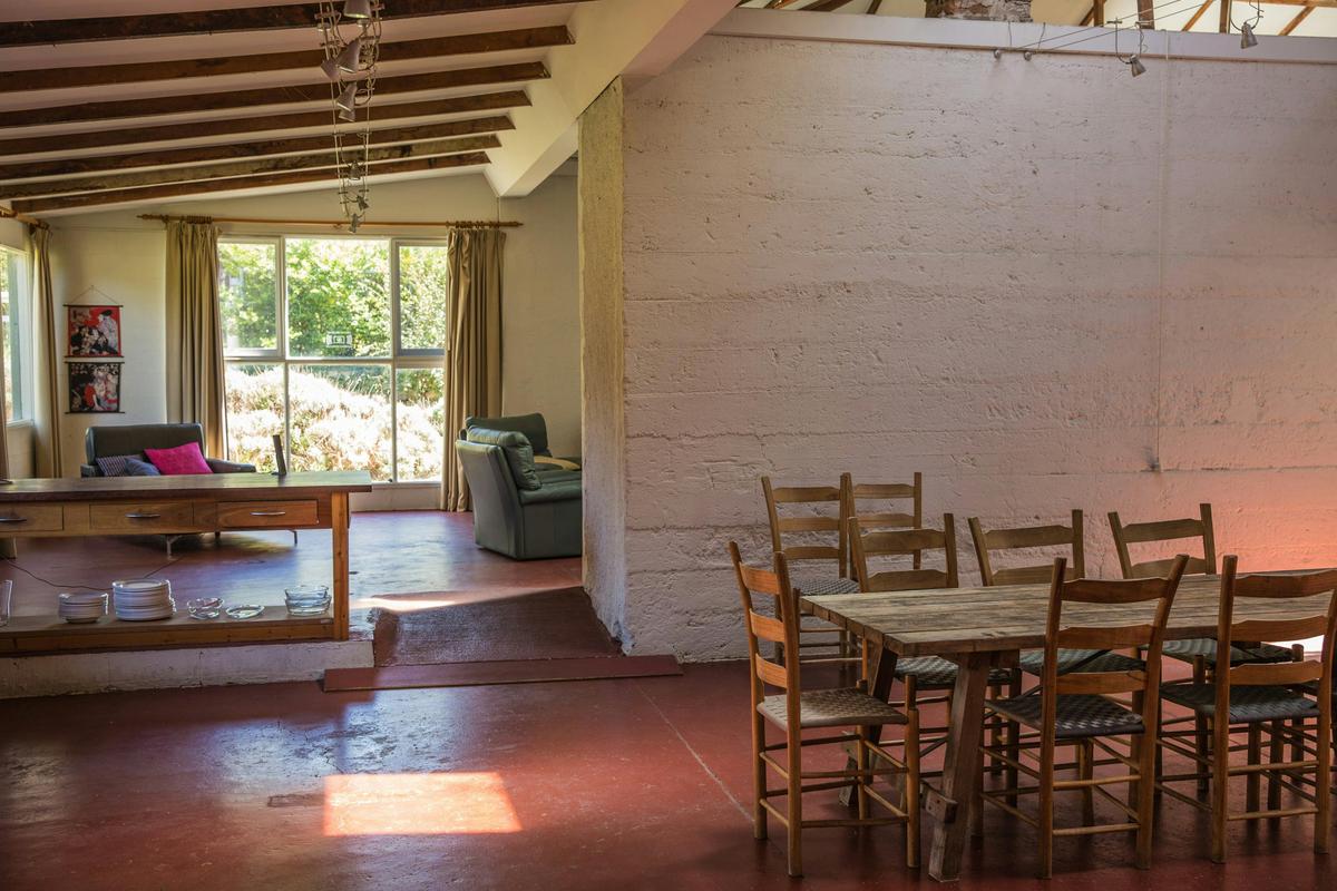 Guests share a modern country kitchen and dining area with open fire places