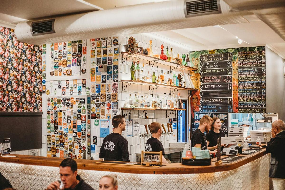 Group of people working behind a bar