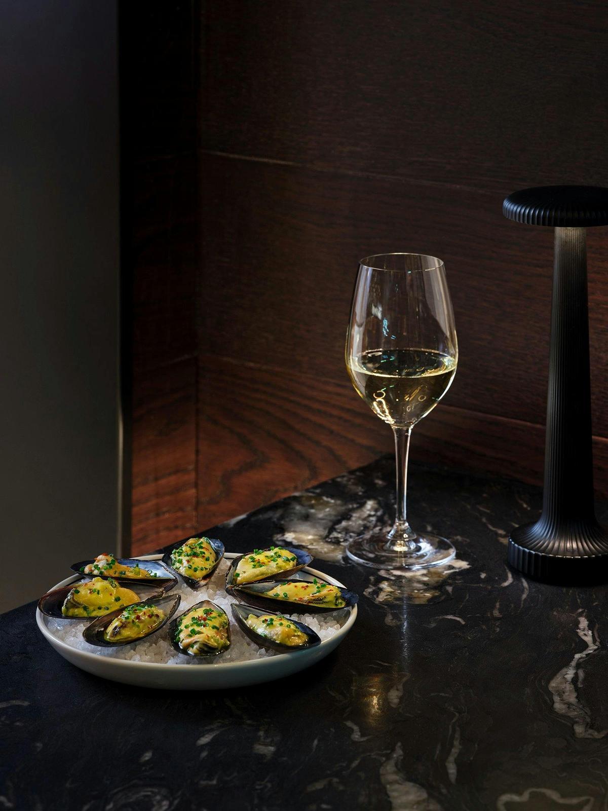 White wine and oysters presented on a table