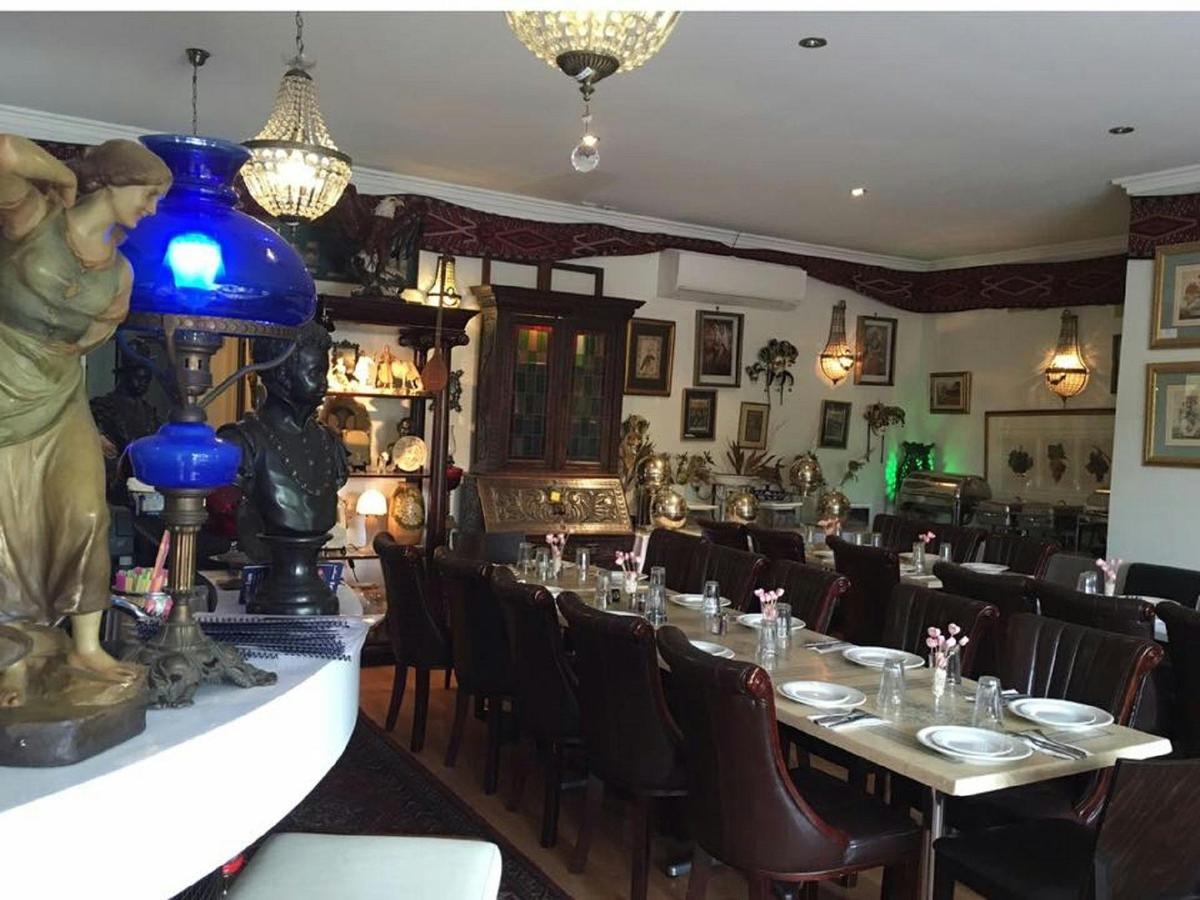 Empty restaurant setting with cutlery and crockery laid out on table