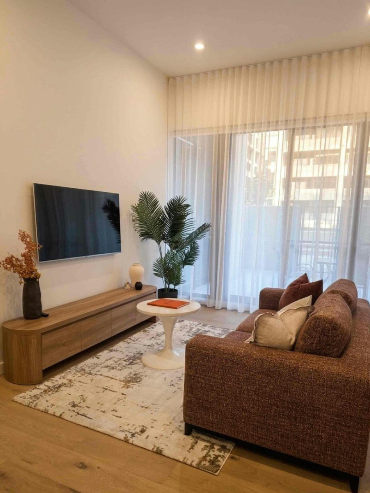 Large windows flood the main lounge area with natural light, creating an inviting space to rest.