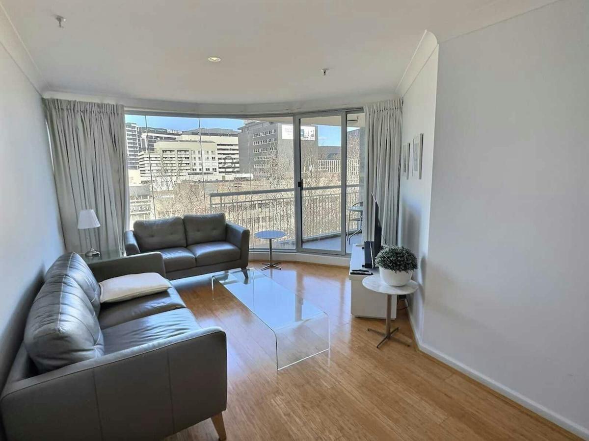 Bright open-plan apartment interior with large windows.