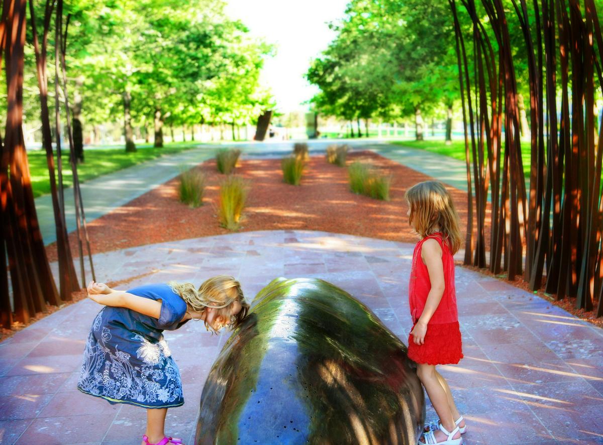Children playing among the sculptures.