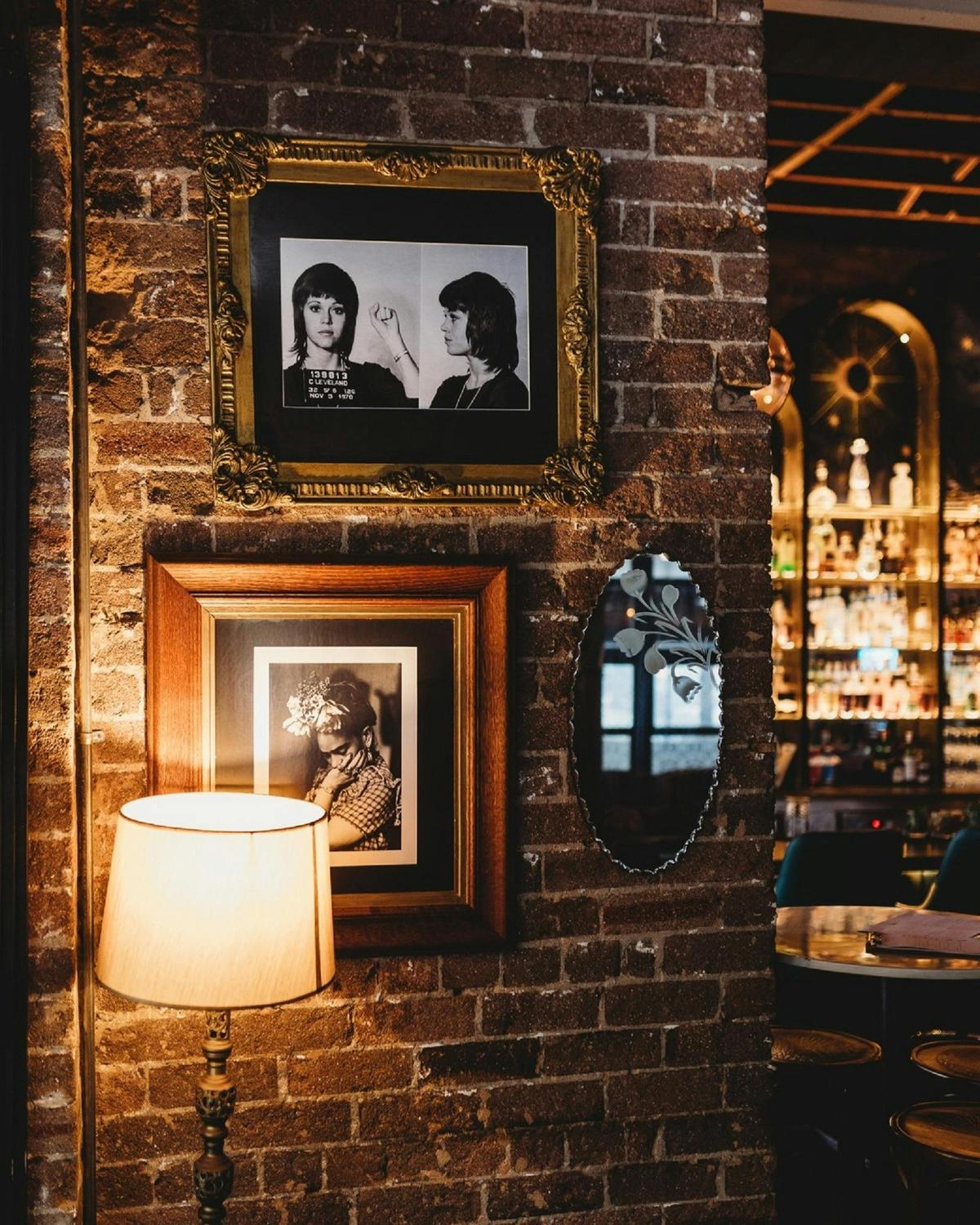 Brick wall with portraits in dining area