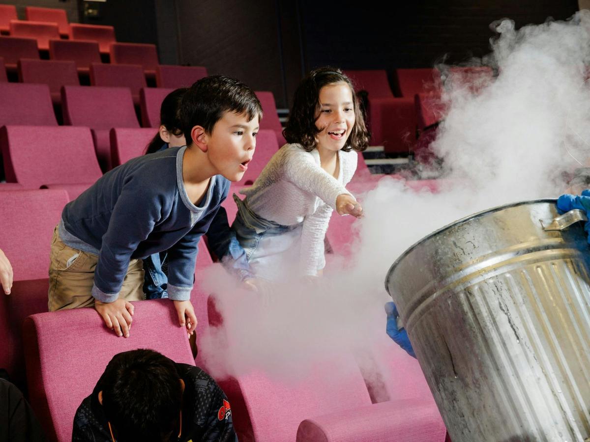 Two children participating in a science show using liquid nitrogen at Questacon
