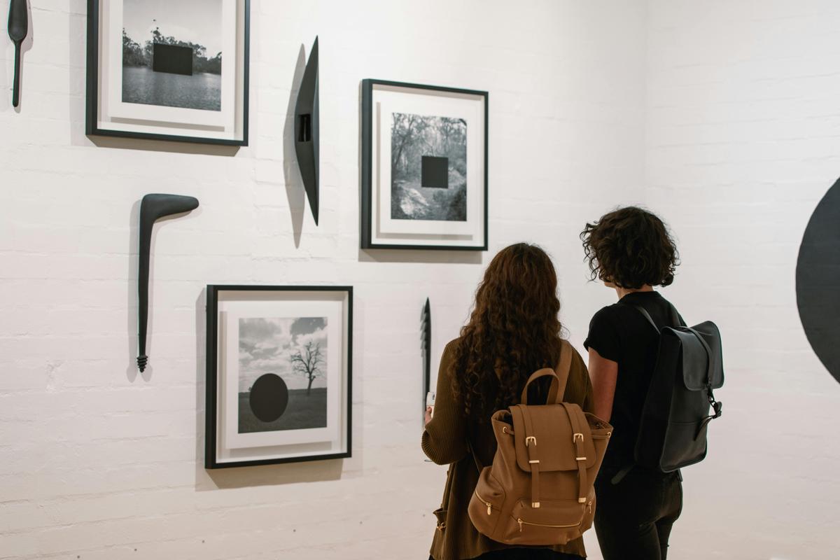 Gallery visitor take in works by James tylor