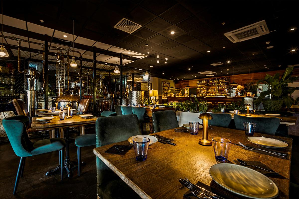 Inside dining area of Charlie's of Darwin with velvet seats in front of the bar
