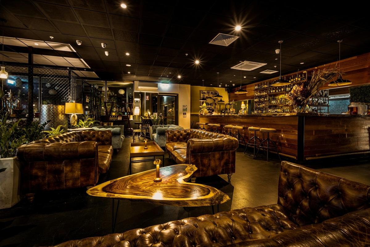 Chesterfield couches in front of the bar at Charlie's of Darwin