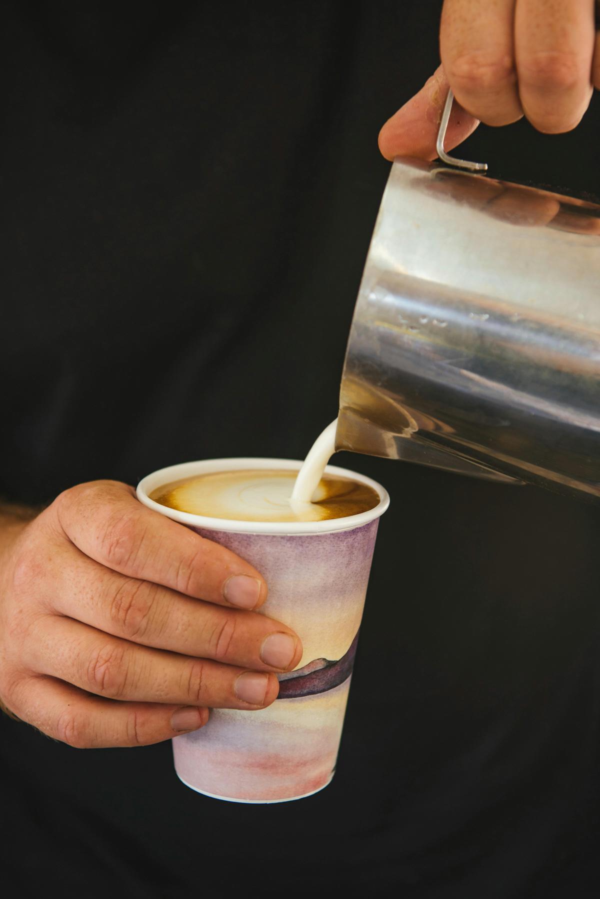 Darwin Ski Club employee pouring a cup of coffee