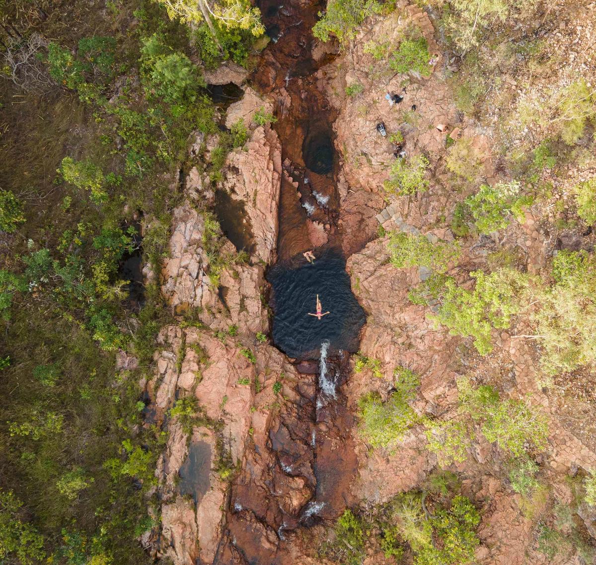 Aerial view of woman swimming at Buley Rockhole in Litchfield National Park