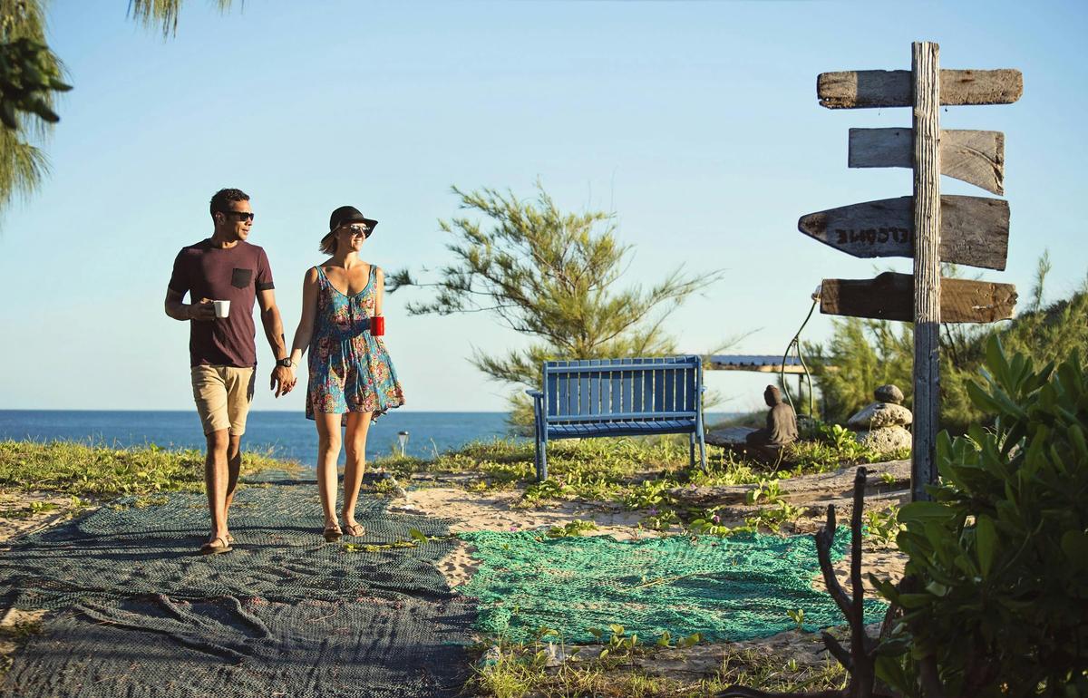 Couple walking together back to the Banu Banu Resort from the beach in East Arnhem Land