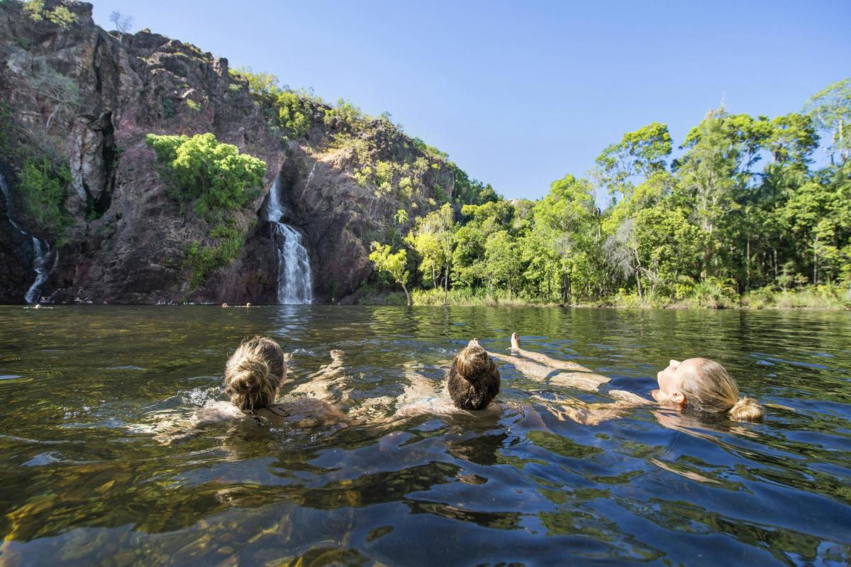 Three visitors enjoying Wangi Falls, Litchfield National Park
