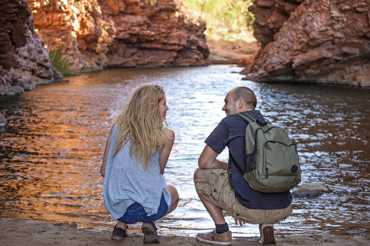 Visitors looking at the water in Simpsons Gap