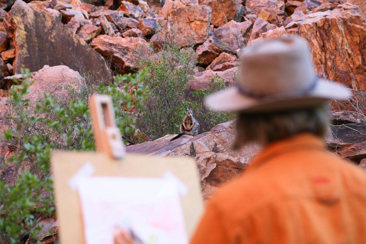 Painting outdoors with a wallaby watching on