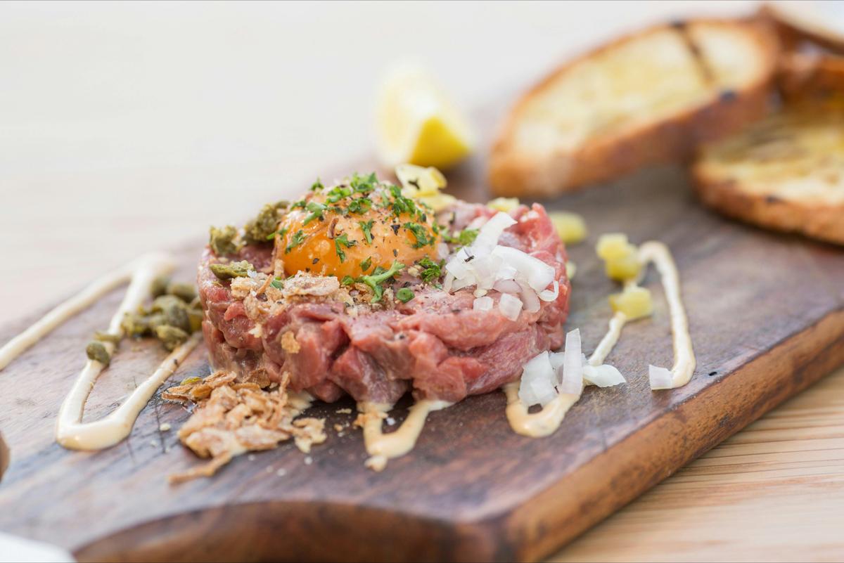 Steak tartare, egg yolk, condiments