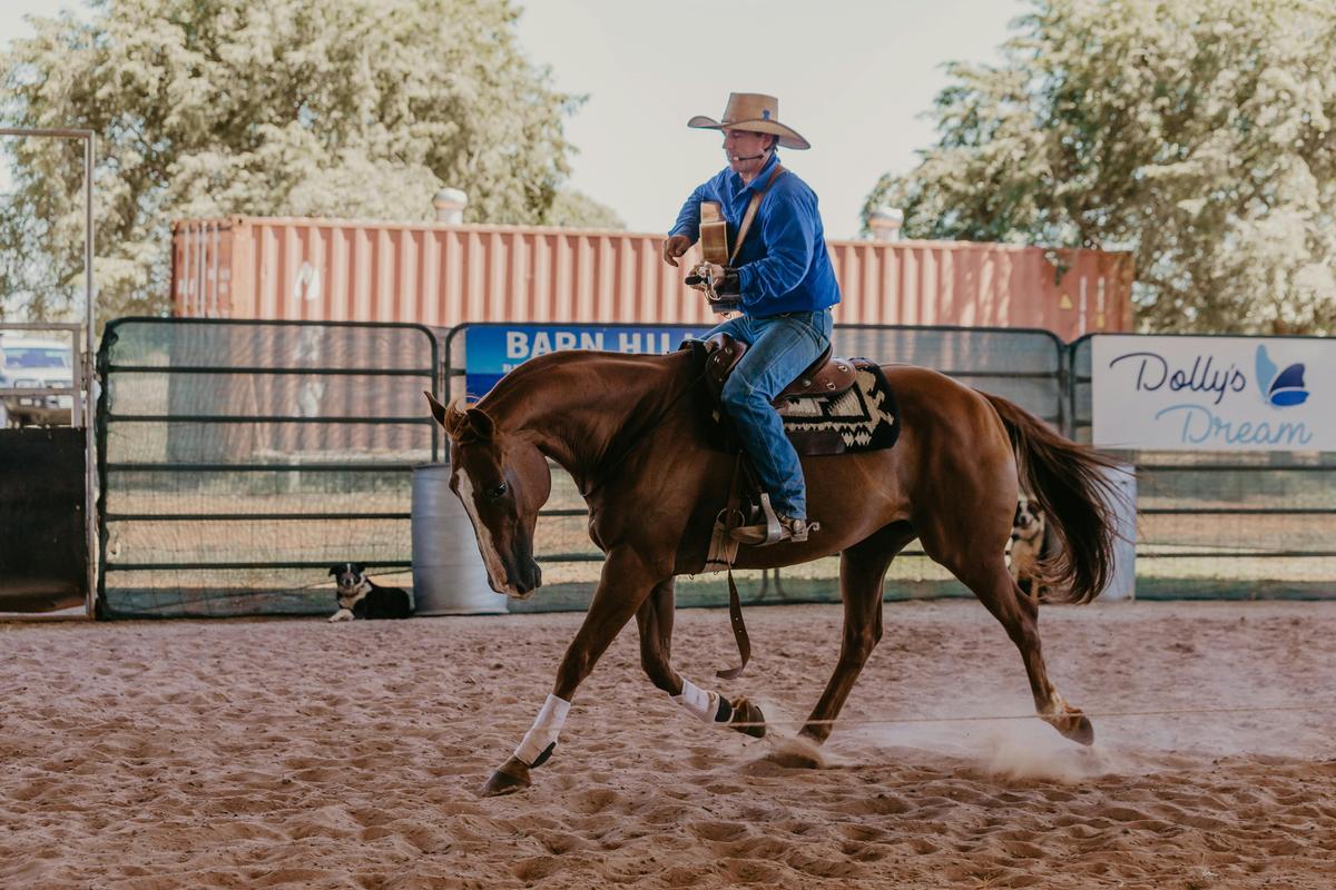 Who said a man can't multitask? Tom Curtain riding a horse, playing guitar and singing!