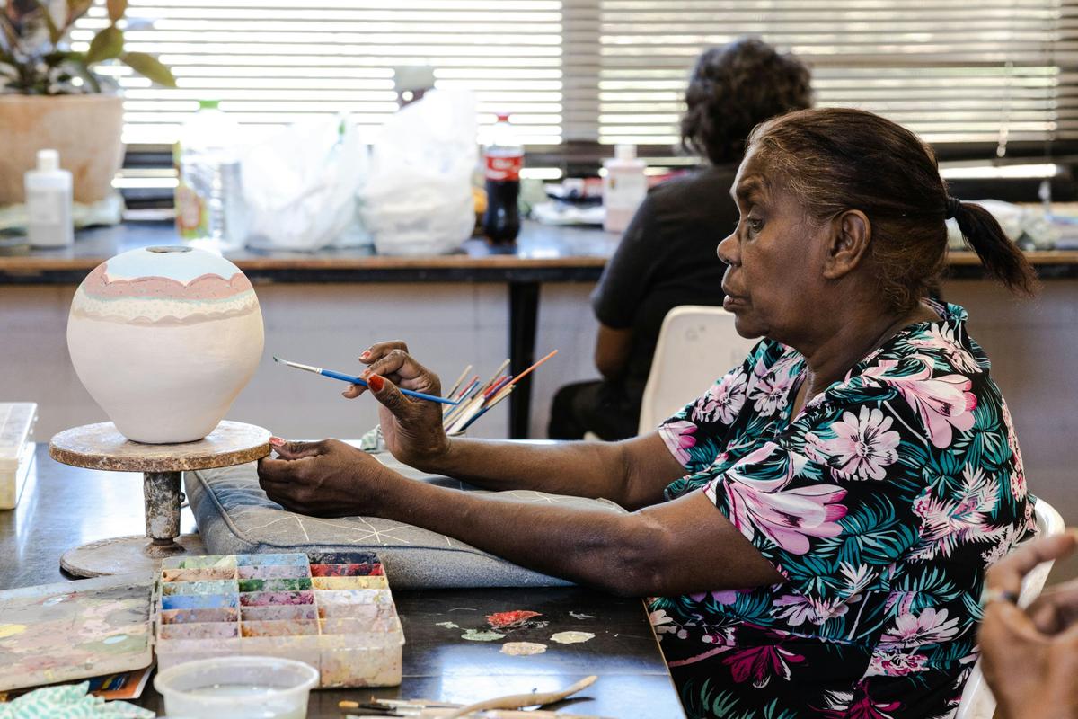 Artist Karen Inkamala paints her pot