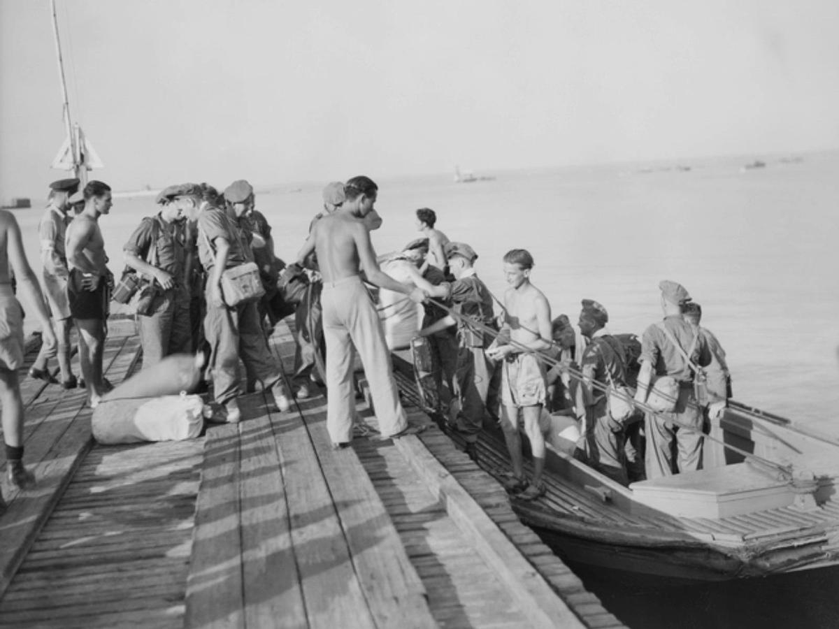 At Doctors Gully jetty where prisoners of war (POWs) are coming ashore from a launch.